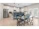 Modern kitchen features stainless steel appliances, granite countertops, pendant lighting, and island seating at 297 Aylesbury Blvd, Mcdonough, GA 30252