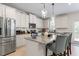 Modern kitchen features stainless steel appliances, granite countertops, pendant lighting, and island seating at 297 Aylesbury Blvd, Mcdonough, GA 30252