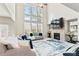 Inviting living room with a cozy fireplace, soaring ceilings, large windows, and modern decor at 297 Aylesbury Blvd, Mcdonough, GA 30252