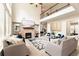 Bright living room featuring high ceilings, fireplace, modern furnishings, and staircase leading to the second floor at 297 Aylesbury Blvd, Mcdonough, GA 30252