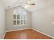 Bright bedroom with hardwood floors, large window with shutters, and a ceiling fan at 3707 Vineyards Lake Nw Cir # 22, Kennesaw, GA 30144