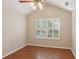 Bedroom featuring laminated flooring and window with shutters at 3707 Vineyards Lake Nw Cir # 22, Kennesaw, GA 30144
