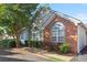 A well-maintained home featuring brick and siding, and arched windows, surrounded by lush greenery at 3707 Vineyards Lake Nw Cir # 22, Kennesaw, GA 30144