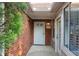 Inviting front entrance with brick facade, white door with sidelights and covered porch with brick flooring at 3707 Vineyards Lake Nw Cir # 22, Kennesaw, GA 30144