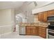 Bright kitchen featuring granite countertops, wooden cabinets, and stainless steel appliances at 3707 Vineyards Lake Nw Cir # 22, Kennesaw, GA 30144