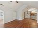 Open concept living room with hardwood floors, wainscoting, and access to kitchen and dining area at 3707 Vineyards Lake Nw Cir # 22, Kennesaw, GA 30144