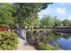 Scenic view of the community pond with a bridge, gazebo, and lush landscaping at 3707 Vineyards Lake Nw Cir # 22, Kennesaw, GA 30144