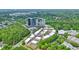 Aerial view of townhome community surrounded by green trees, located near business buildings at 1598 Aldworth Se Pl, Marietta, GA 30339