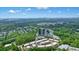 Overhead shot shows townhome community surrounded by forest with office building nearby at 1598 Aldworth Se Pl, Marietta, GA 30339