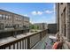 Relaxing balcony with outdoor seating, decorative rug, and view of charming brick residences at 1598 Aldworth Se Pl, Marietta, GA 30339