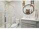 Stylish bathroom features a shower, vanity with pendant lights and accent mirror at 1598 Aldworth Se Pl, Marietta, GA 30339