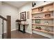 Well-lit hallway features a console table, artwork and built-in shelving at 1598 Aldworth Se Pl, Marietta, GA 30339