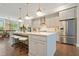 Bright kitchen features stainless steel appliances, white quartz countertops, and a large island at 1598 Aldworth Se Pl, Marietta, GA 30339