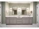 Elegant bathroom with double vanity, marble floors, framed mirrors, and sconce lighting fixtures at 1598 Aldworth Se Pl, Marietta, GA 30339