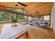Spacious screened porch with wood floors and comfortable seating for outdoor relaxation at 1895 Flat Shoals Se Rd, Atlanta, GA 30316