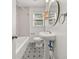 Charming bathroom with a pedestal sink, unique floor tiles, and a bathtub at 1895 Flat Shoals Se Rd, Atlanta, GA 30316