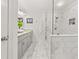 Modern bathroom featuring a glass shower, marble tile, and double vanity at 1895 Flat Shoals Se Rd, Atlanta, GA 30316
