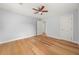 This bedroom features hardwood floors, neutral walls, a ceiling fan, and a door to the closet and hallway at 1895 Flat Shoals Se Rd, Atlanta, GA 30316