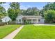 Charming single-story home with a well-manicured lawn and inviting front porch at 1895 Flat Shoals Se Rd, Atlanta, GA 30316