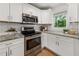 Updated kitchen featuring granite countertops, stainless steel appliances and bright white cabinets at 1895 Flat Shoals Se Rd, Atlanta, GA 30316