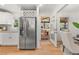 Bright kitchen featuring stainless steel appliances, white cabinetry, and a doorway leading to an outdoor deck at 1895 Flat Shoals Se Rd, Atlanta, GA 30316
