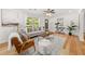 Bright living room featuring hardwood floors, a ceiling fan, and large windows at 1895 Flat Shoals Se Rd, Atlanta, GA 30316