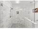 Modern walk-in shower with marble tile, a bench, and a built-in niche at 1895 Flat Shoals Se Rd, Atlanta, GA 30316