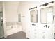 Bright bathroom featuring double vanity, stone floor, soaking tub, walk-in shower, and modern lighting at 2504 Hannah Haven Dr, Conyers, GA 30012