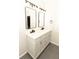 Bright bathroom featuring double vanity, stone floor, and modern lighting at 2504 Hannah Haven Dr, Conyers, GA 30012