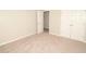 Bedroom with carpet, closet with double doors, and view into hallway at 2504 Hannah Haven Dr, Conyers, GA 30012