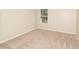 Bedroom with neutral carpet, baseboards, and walls; large window lets in natural light at 2504 Hannah Haven Dr, Conyers, GA 30012