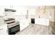 Bright kitchen boasts white cabinets, stainless steel appliances, stone backsplash, and modern pendant lighting at 2504 Hannah Haven Dr, Conyers, GA 30012