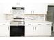 Contemporary kitchen featuring white cabinets, stone backsplash, stainless steel appliances, and quartz countertops at 2504 Hannah Haven Dr, Conyers, GA 30012