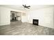 Spacious living room showcasing wood-look floors, a fireplace, and seamless access to the kitchen area at 2504 Hannah Haven Dr, Conyers, GA 30012
