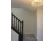 Carpeted staircase with stained railing and elegant light fixture at 2504 Hannah Haven Dr, Conyers, GA 30012