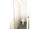 Small powder room with toilet and modern tile floor at 2504 Hannah Haven Dr, Conyers, GA 30012