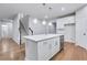 View of kitchen island, stainless steel dishwasher, and staircase in an open floor plan at 6096 Marigold Way, Atlanta, GA 30349