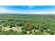 Aerial view of a wooded homesite with a house-shaped marker pinned to its location at 8587 Cumming Se Hwy, Canton, GA 30115