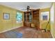 A bedroom featuring a ceiling fan, wood floors, and a built-in desk with shelves at 8587 Cumming Se Hwy, Canton, GA 30115