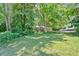 Charming single-story home nestled on a lot with mature trees and a well-maintained, expansive lawn at 8587 Cumming Se Hwy, Canton, GA 30115