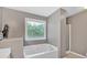 Cozy bathroom featuring a soaking tub under a bright window and separate shower at 1331 Red Hill Rd, Marietta, GA 30008
