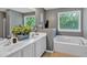 Bathroom with double sink vanity, soaking tub, and bright windows at 1331 Red Hill Rd, Marietta, GA 30008