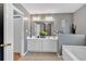 Bathroom with double vanity, bright mirrors, and a soaking tub at 1331 Red Hill Rd, Marietta, GA 30008