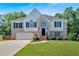 Charming two-story brick home with a well-maintained front lawn, two-car garage, and beautiful landscaping at 1331 Red Hill Rd, Marietta, GA 30008