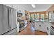 Bright eat-in kitchen featuring stainless steel appliances, white cabinetry, and hardwood floors at 1331 Red Hill Rd, Marietta, GA 30008