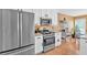 Modern kitchen boasting stainless steel appliances, white cabinets, and hardwood floors with an eat-in area at 1331 Red Hill Rd, Marietta, GA 30008