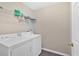 Well-lit laundry room featuring modern white washer and dryer at 1331 Red Hill Rd, Marietta, GA 30008