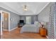 Main bedroom featuring a tray ceiling, hardwood floors, and natural lighting at 1331 Red Hill Rd, Marietta, GA 30008