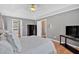 Bright main bedroom with a tray ceiling, hardwood floors, and ensuite bath at 1331 Red Hill Rd, Marietta, GA 30008