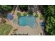 Aerial view of a backyard pool with spa, patio, and lush landscaping at 3560 Greenside Ct, Dacula, GA 30019